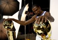 Kevin Durant poses with two Larry O'Brien NBA Championship Trophies.